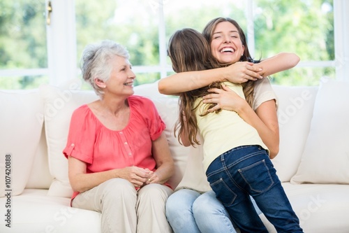 Girl hugging mother with granny 