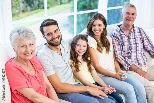 Portrait of smiling family sitting on sofa