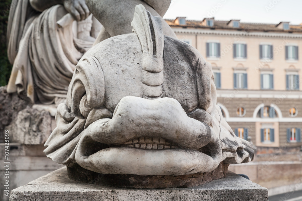 Ancient dolphin sculpture on Piazza del Popolo
