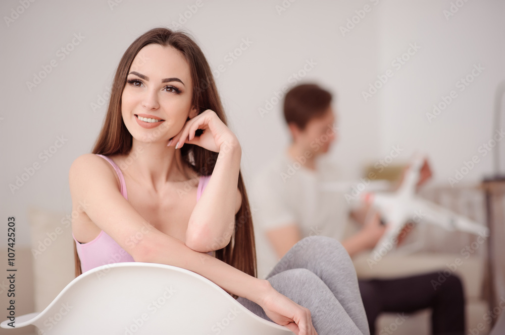 Pleasant girl sitting in the chair