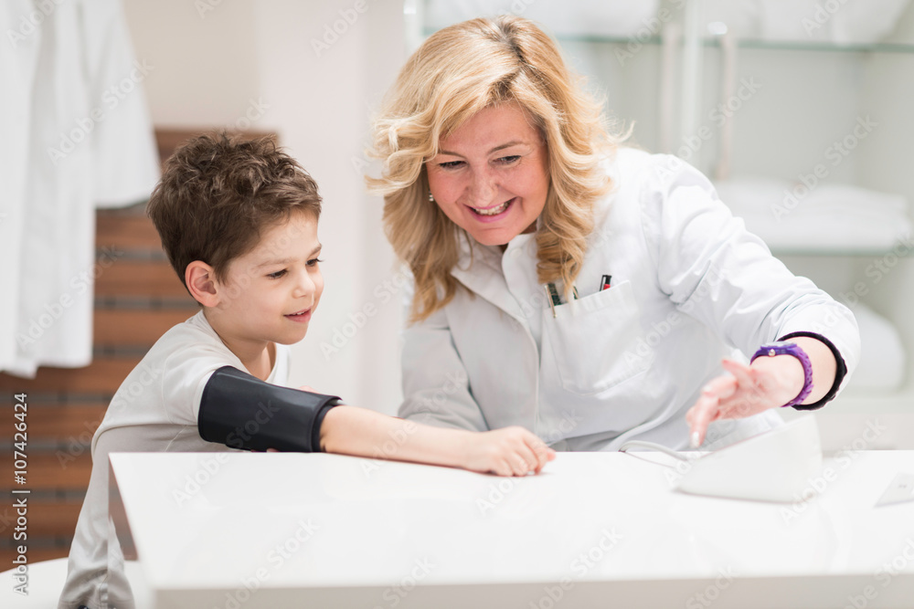 Pediatrician with little boy, measuring blood pressure Pediatrician with little boy, measuring blood pressure