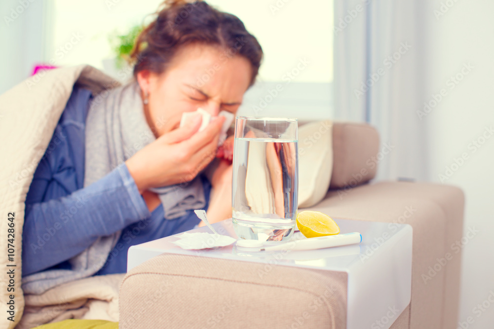 Sick woman sneezing into tissue. Flu. Woman caught cold Sick woman sneezing into tissue. Flu. Woman caught cold