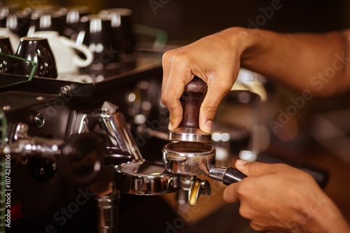 Close-up of barista preparing coffee