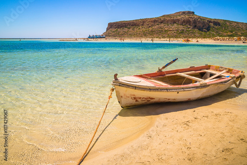 Fishing boat docked to coast on the beach of Crete, Greece