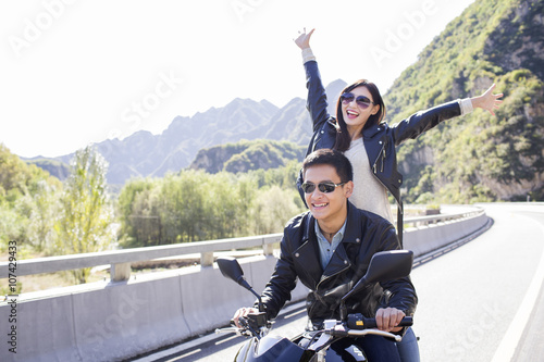 Young couple riding motorcycle together