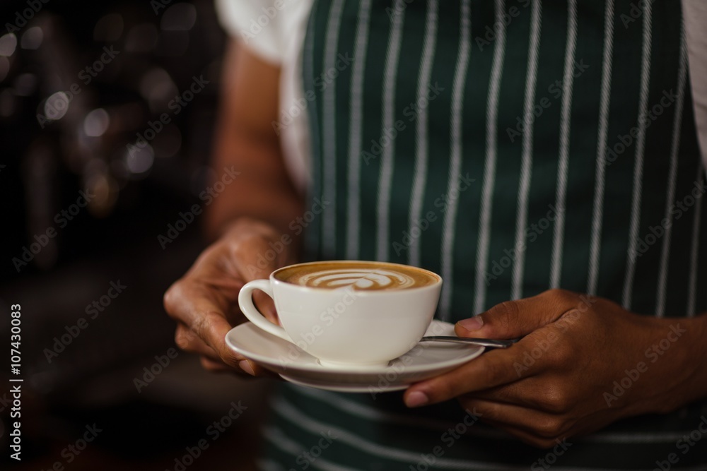 Close up of barista holding cappuccino Close up of barista holding cappuccino