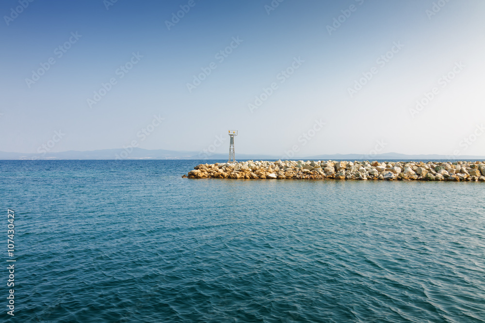 Sea pier on background of Mediterranean sea from Nea Fokia, Greece.