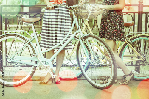 Women riding and travel by vintage city bicycles