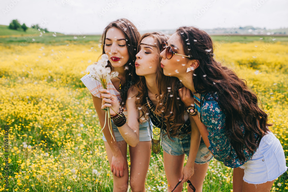 3 beautiful hippie girl in a field of yellow flowers 3 beautiful hippie girl in a field of yellow flowers