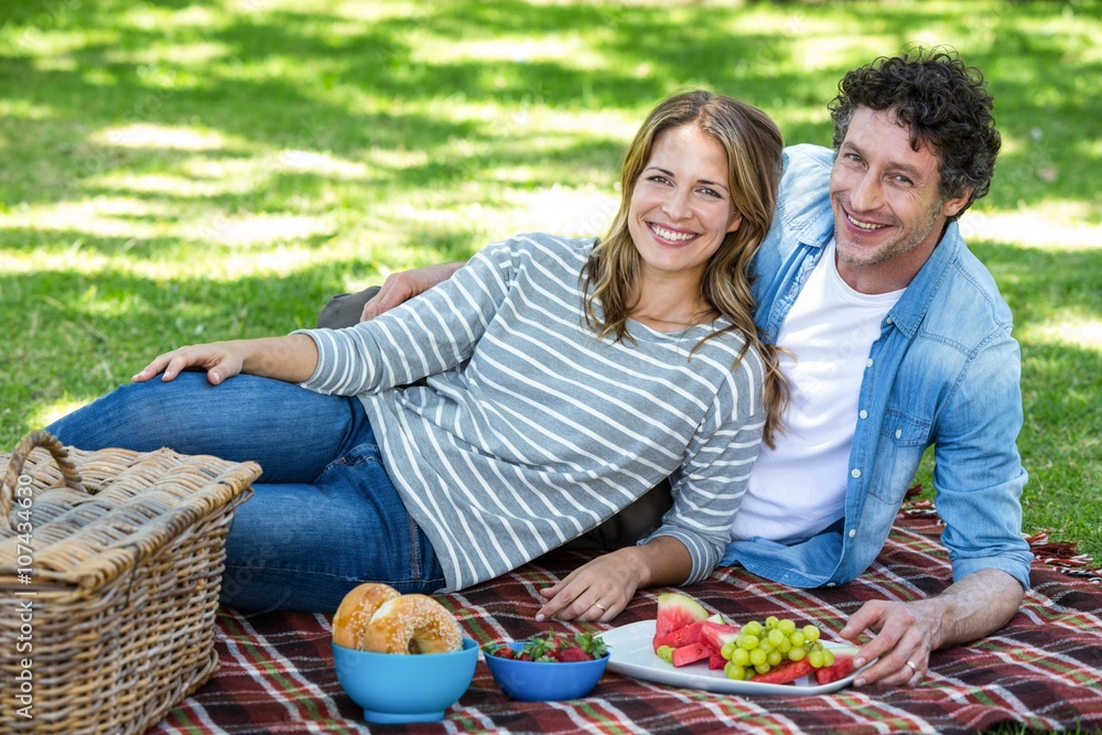 Couple having a picnic in a park Couple having a picnic in a park