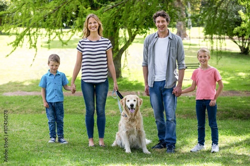 Family with dog in the park on a sunny day