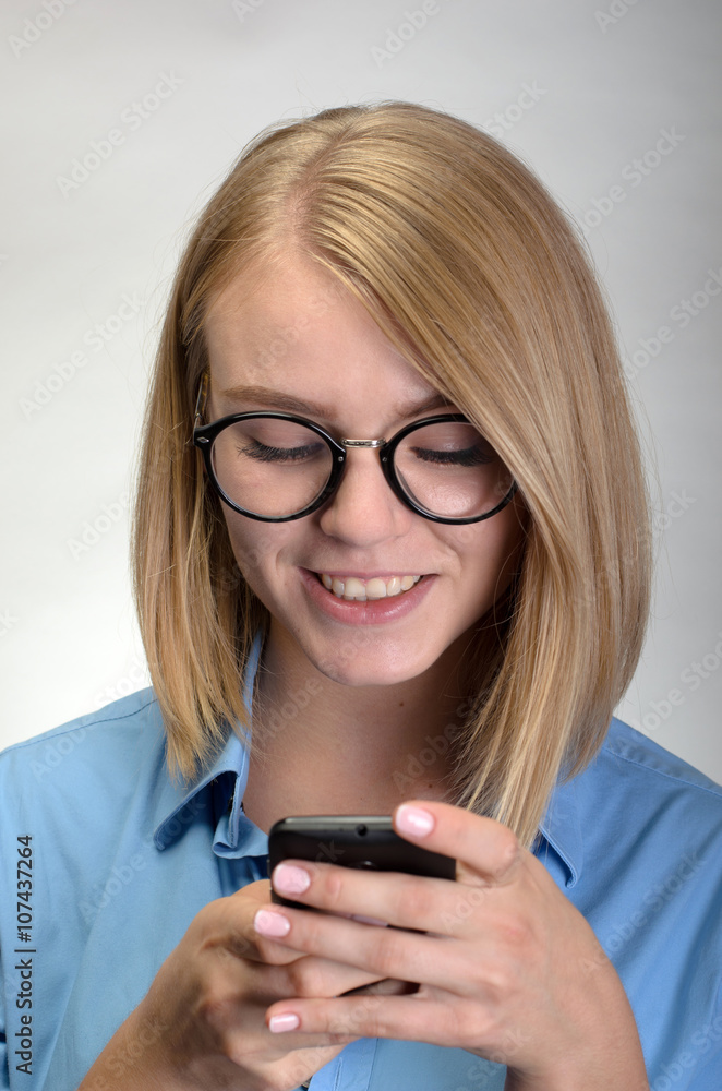 Pretty young woman sending text message or chatting Pretty young woman sending text message or chatting