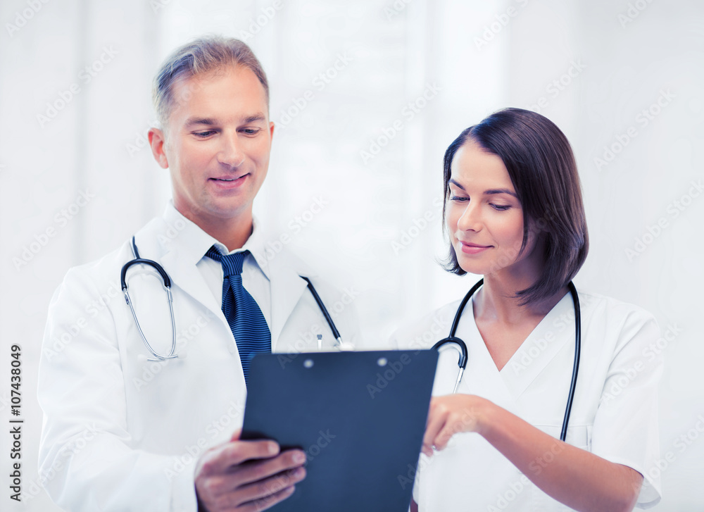 two doctors writing prescription two doctors writing prescription