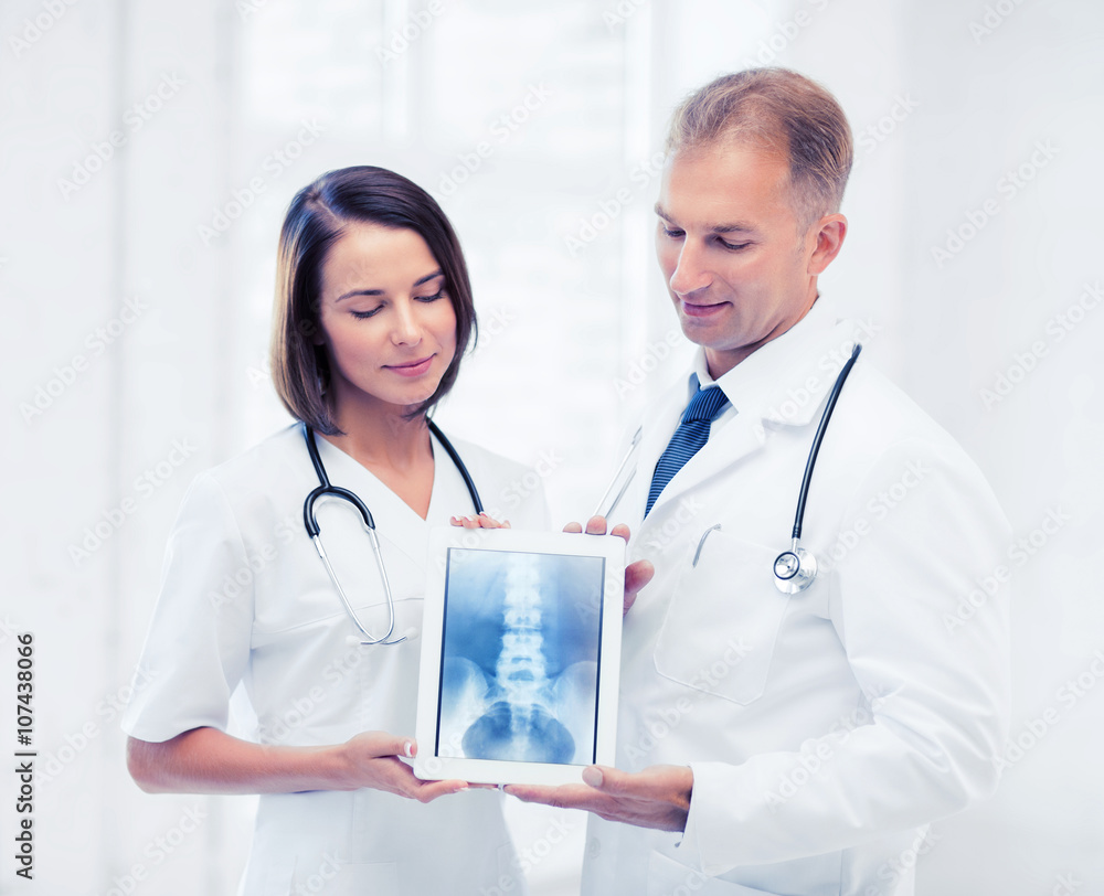 two doctors showing x-ray on tablet pc two doctors showing x-ray on tablet pc