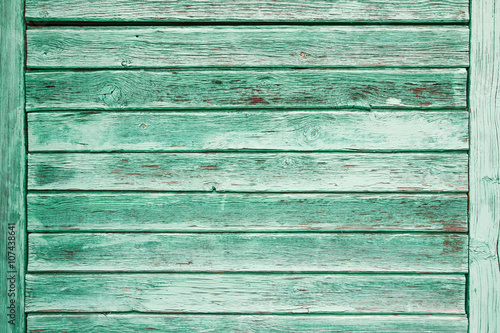 Green peeling paint wooden background.