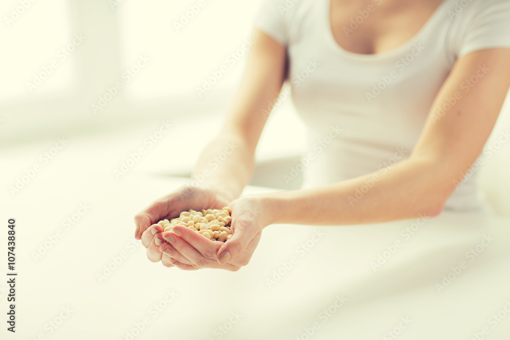 Obraz premium close up of woman hands holding peeled peanuts