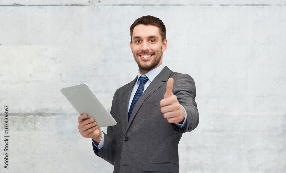 young businessman with tablet pc showing thumbs up young businessman with tablet pc showing thumbs up