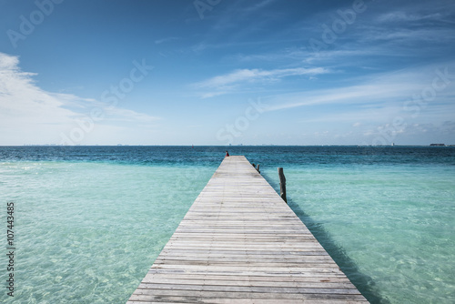 wooden dock into blue tropical sea in Isla Mujeres, Yucatan Mexico