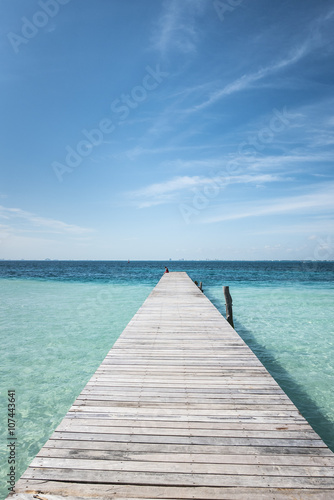 wooden dock into blue tropical sea in Isla Mujeres  Yucatan Mexico