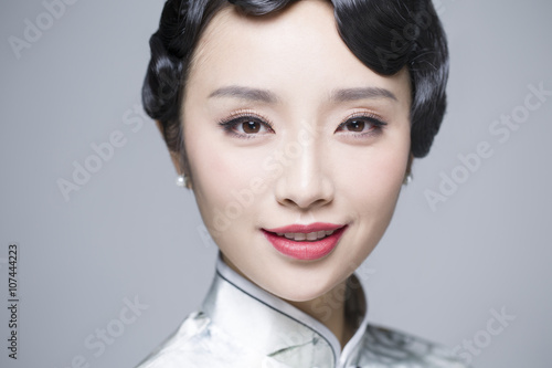 Headshot of young beautiful woman in traditional cheongsam photo