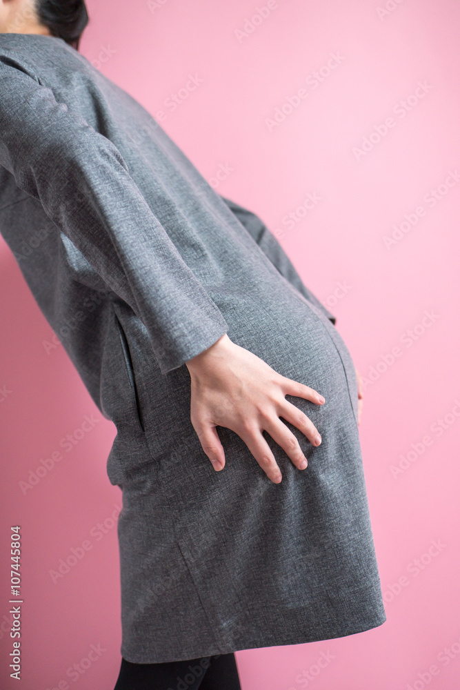 お尻を押さえる女性 Stock Photo | Adobe Stock