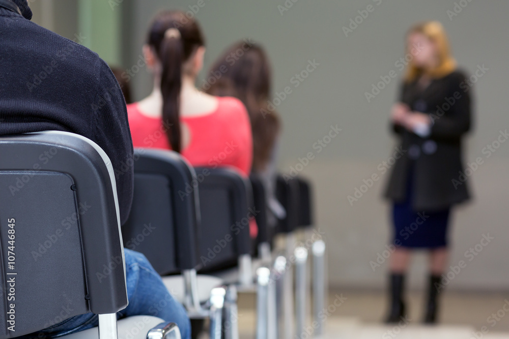 Row of Seats in Conference Room and Body of Lecturer Row of Seats in Conference Room and Body of Lecturer