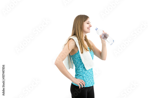Young fitness girl drinking water