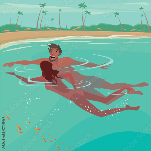 Happy couple swimming in the sea near the beach - Honeymoon or vacation concept