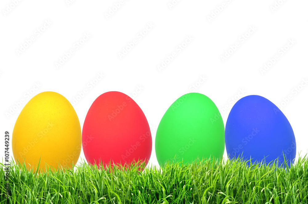 Row of Easter eggs on grass with a white background