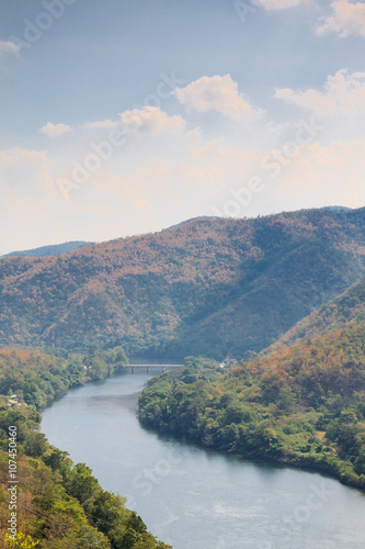 View of river from greenery mountain with blue sky