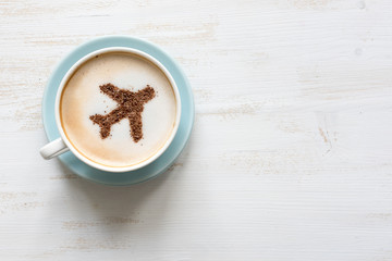 Airplane made of cinnamon in coffee. Cup of Cuppuccino. Travel concept