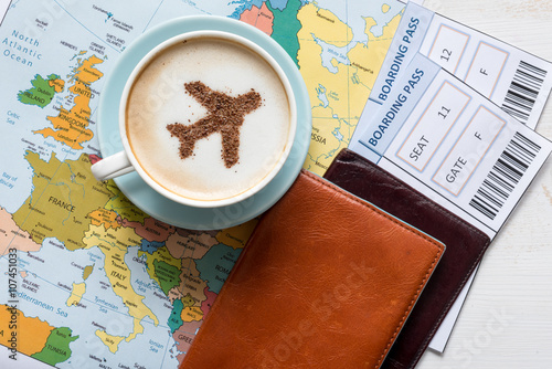 Aircraft made ofcinnamon in cappuccino, passports and boarding passes with Europe map. Travel concept