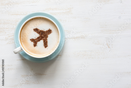 Airplane made of cinnamon in coffee. Cup of Cuppuccino. Travel concept
