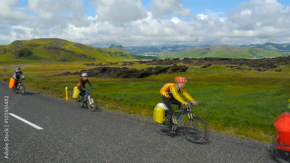 Extreme cycling. Cyclists riding on a mountain road in Iceland. Beautiful scenery and nature of Iceland. Extreme cycling. Cyclists riding on a mountain road in Iceland. Beautiful scenery and nature of Iceland.