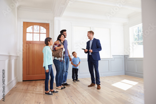 Realtor Showing Hispanic Family Around New Home
