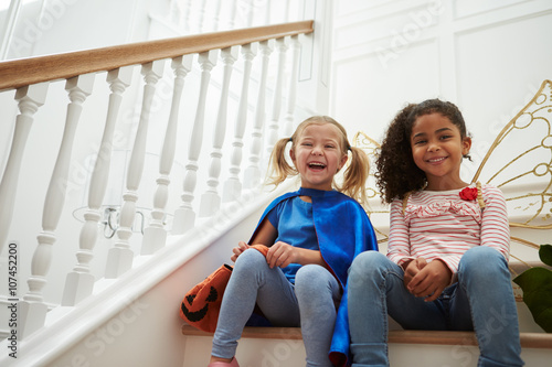 Konstfotografi Two Girls Playing Dressing Up Games Sitting On Stairs
