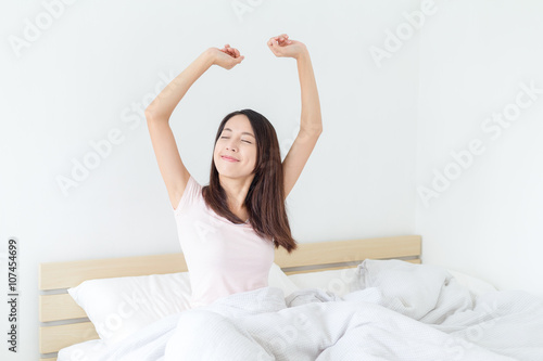 Woman wake up and stretch her arm