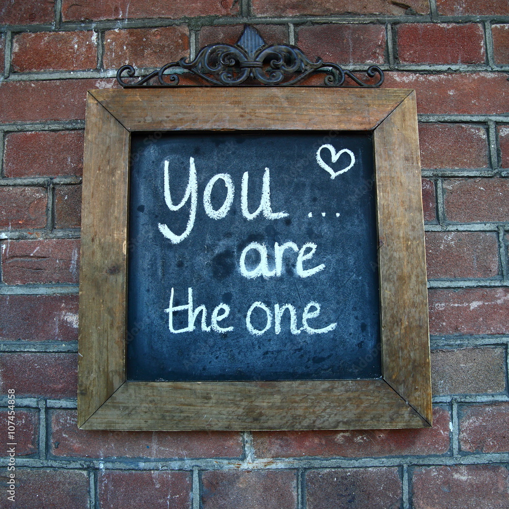 Fototapeta premium love/ saying about love written on a chalk board