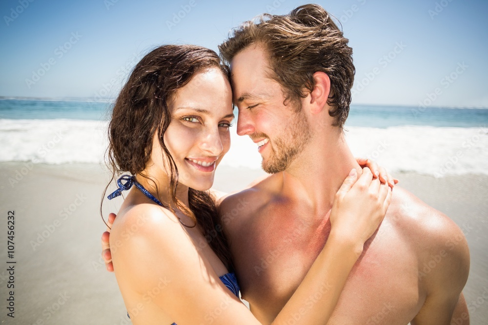 Young couple embracing each other on the beach Young couple embracing each other on the beach