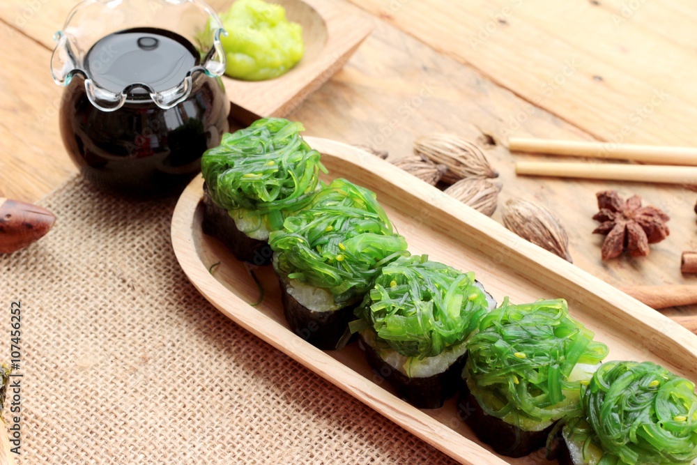 Sushi roll and seaweed salad is delicious.