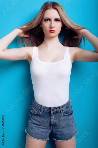 Fashion photo of young magnificent girl with red lips posing ove
