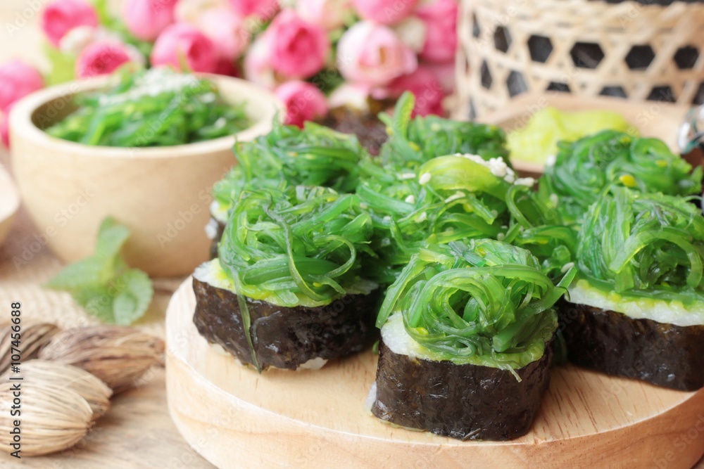 Sushi roll and seaweed salad is delicious. Sushi roll and seaweed salad is delicious.
