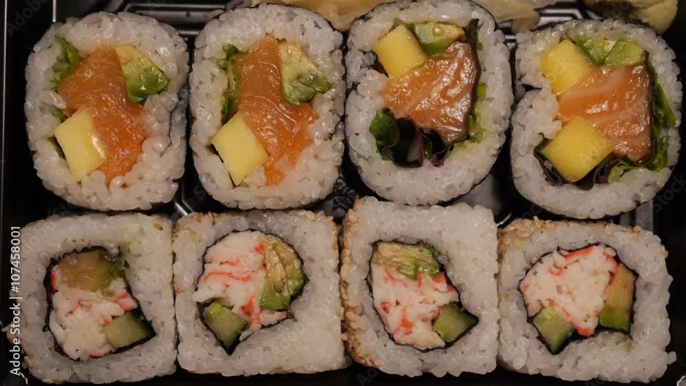 Sushi on tray picked up with chop sticks real time. Sushi on tray picked up with chop sticks real time.