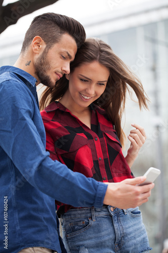 Young couple using smart phone