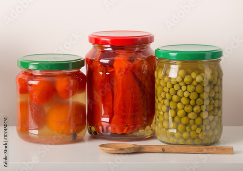 Jars with pickled vegetables on white background