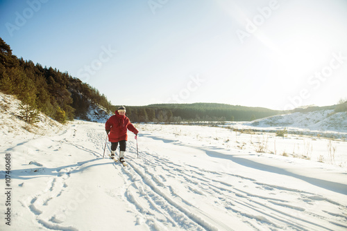 Caucasian woman cross-country skiing in snowy field