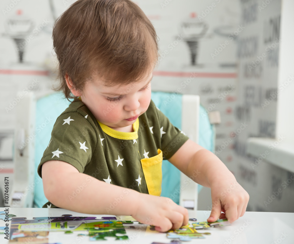 Little boy playing puzzle