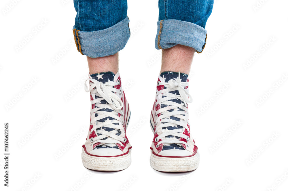 Male hairy legs in red gumshoes on white background