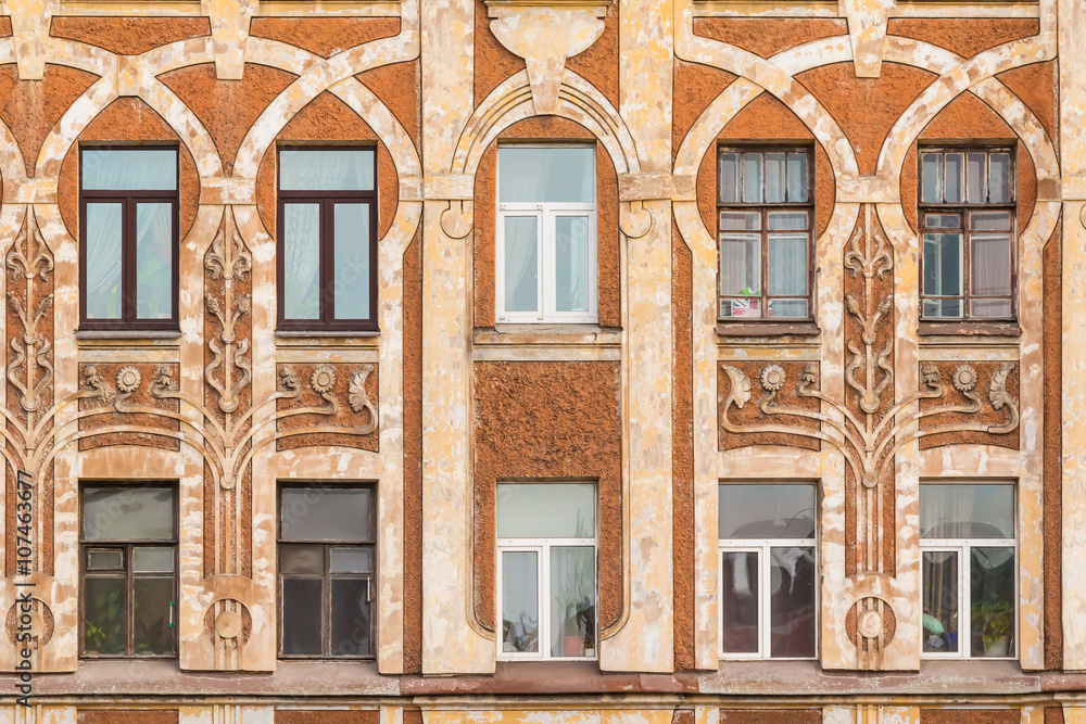 Several windows in row on facade of urban apartment building front view, St. Petersburg, Russia.