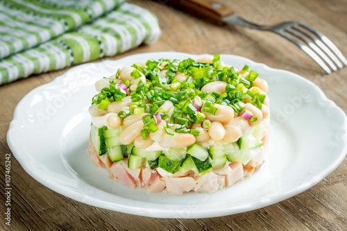 Salad with white beans, cucumber, chicken and green onions
